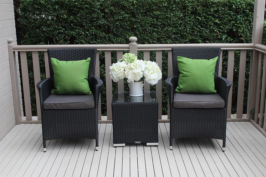 3 piece patio set consisting of 2 black wicker chairs and small black wicker table