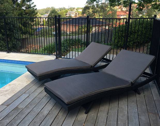 Black outdoor wicker sun loungers