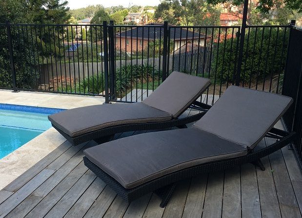 Black outdoor wicker sun loungers